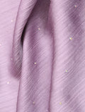 Close-up of purple fabric with small embellishments