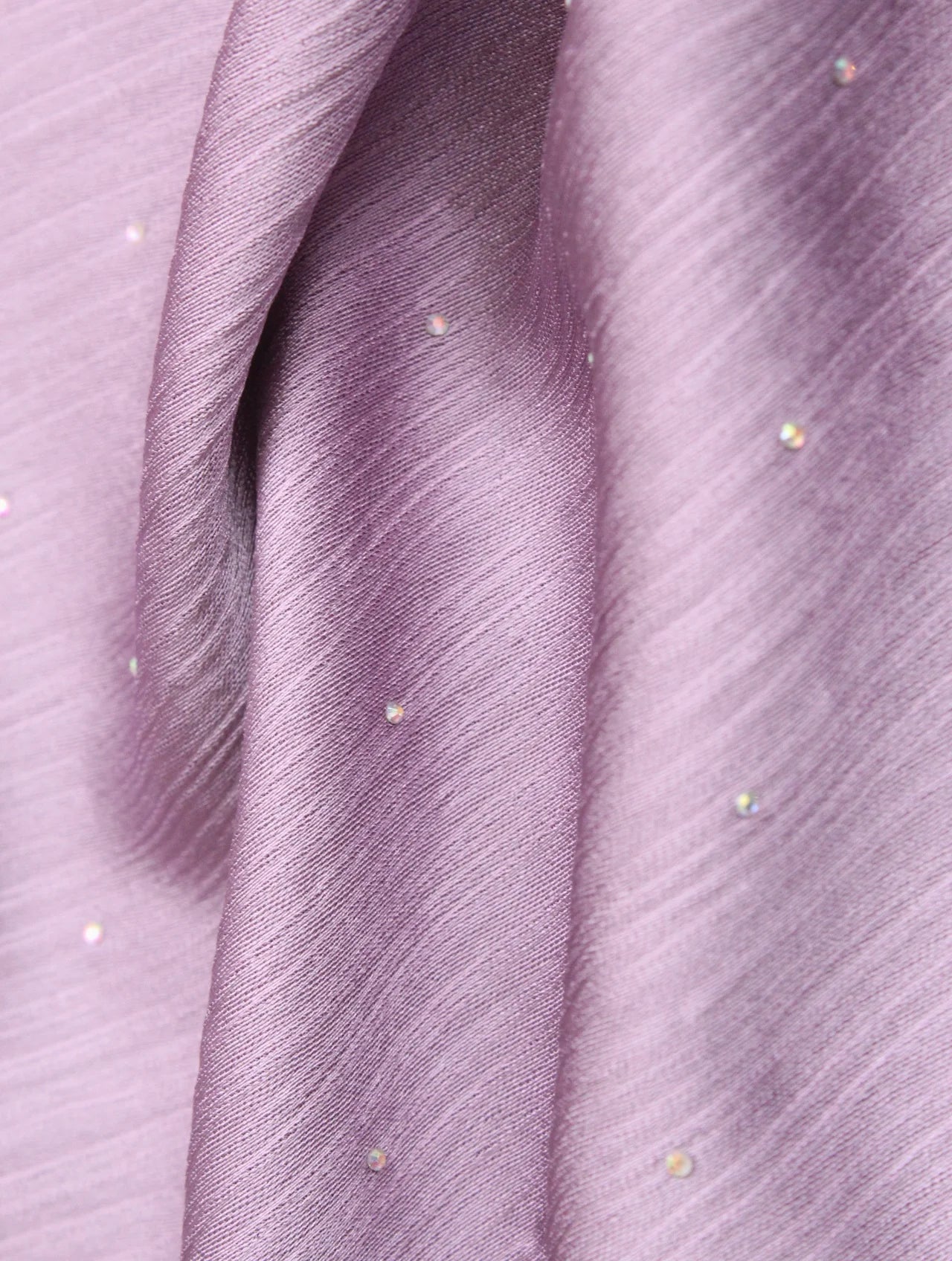 Close-up of purple fabric with small embellishments