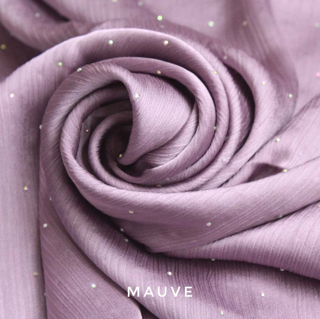 Close-up of purple fabric with small embellishments